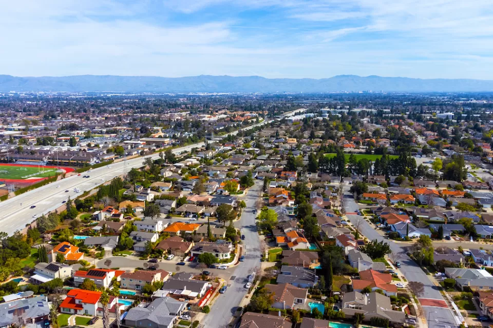 Aerial view of housing and freeway in Cupertino, California.